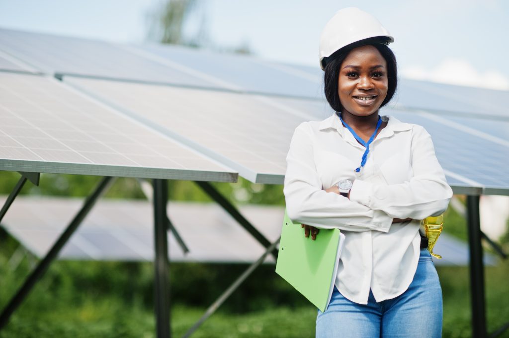 beautiful lady standing besides solar panels